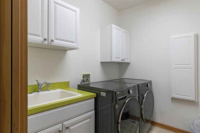 406 Back Nine Ln, Hamilton, MT 59840 - clothes washing area featuring cabinet space, washing machine and dryer, baseboards, and a sink