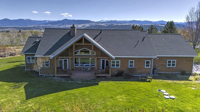 406 Back Nine Ln, Hamilton, MT 59840 - rear view of property with a deck with mountain view, a chimney, and a lawn
