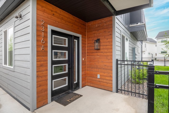 entrance to property featuring fence
