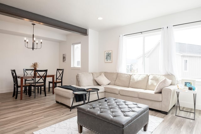 living area featuring a chandelier, recessed lighting, beamed ceiling, and light wood-style floors
