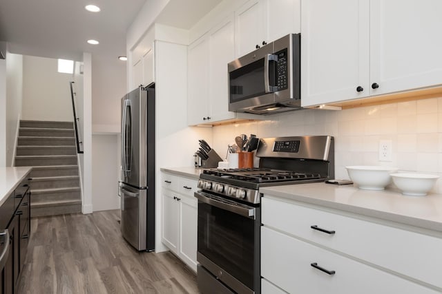 kitchen featuring light countertops, stainless steel appliances, and wood finished floors