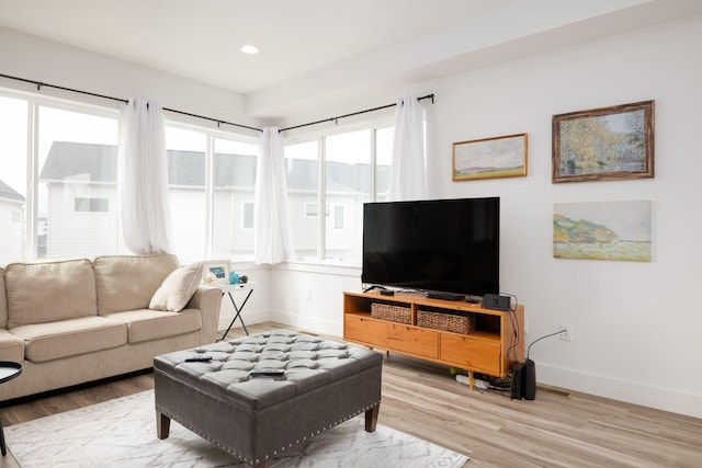 living room featuring wood finished floors, baseboards, and recessed lighting