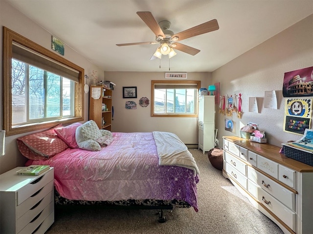 101 11th Ave N, Shelby, MT 59474 - bedroom featuring carpet flooring, a baseboard radiator, and a ceiling fan