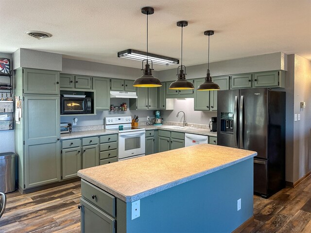 101 11th Ave N, Shelby, MT 59474 - kitchen featuring a sink, white appliances, under cabinet range hood, and green cabinets