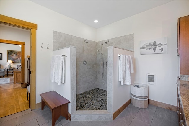 34426 Ridge Rd, Polson, MT 59860 - bathroom with heating unit, walk in shower, baseboards, vanity, and tile patterned floors