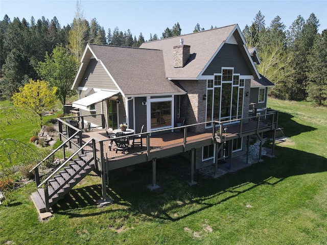 34426 Ridge Rd, Polson, MT 59860 - rear view of property featuring a wooden deck, a lawn, stairway, a shingled roof, and a chimney