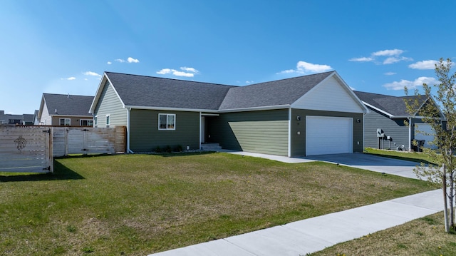 ranch-style house with an attached garage, fence, concrete driveway, a shingled roof, and a front yard
