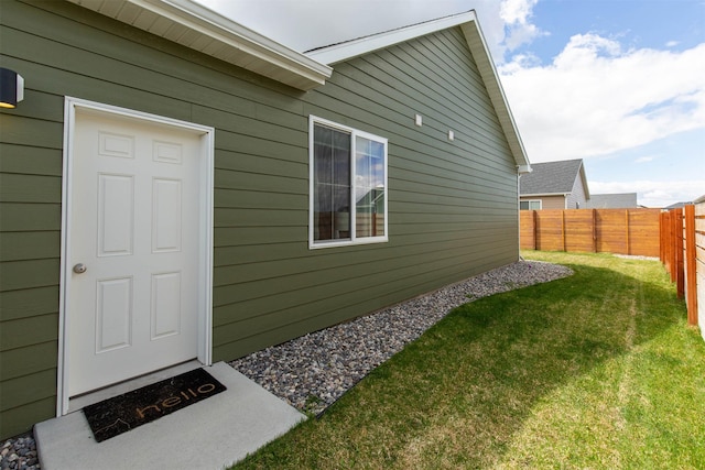 view of property exterior with a yard and a fenced backyard
