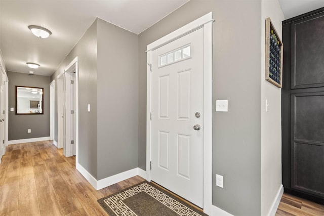 entryway featuring baseboards and light wood-type flooring