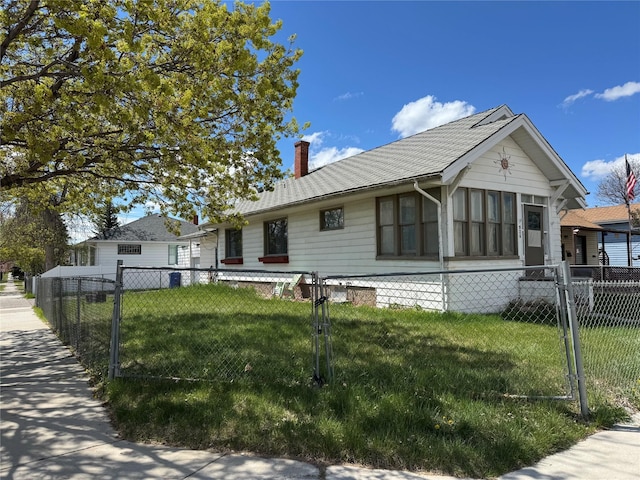 ranch-style home featuring a chimney, a front lawn, and fence private yard