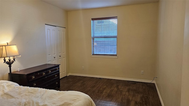 bedroom featuring baseboards, a closet, and wood finished floors