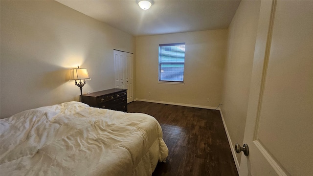 bedroom featuring baseboards and dark wood-type flooring