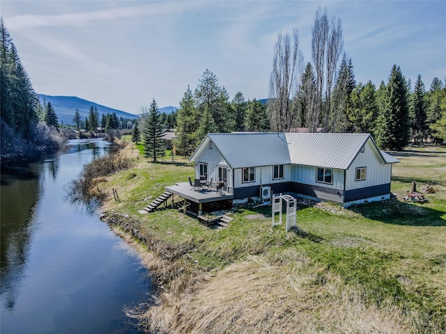 drone / aerial view featuring a water and mountain view