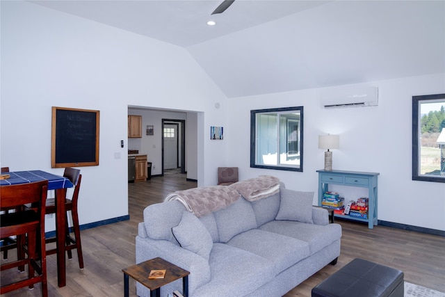 living area with wood finished floors, a ceiling fan, a wall unit AC, baseboards, and vaulted ceiling