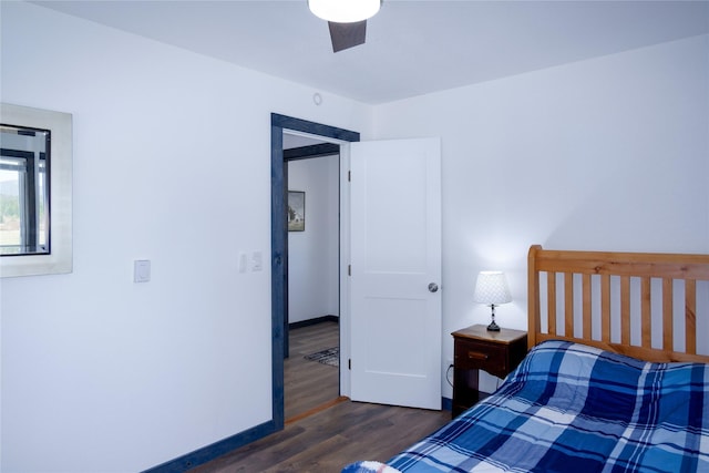 bedroom with baseboards, a ceiling fan, and dark wood-style floors