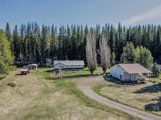drone / aerial view featuring a wooded view
