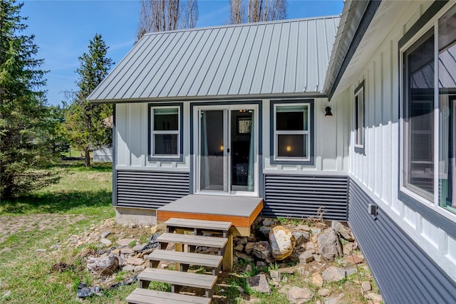 exterior space featuring board and batten siding and metal roof