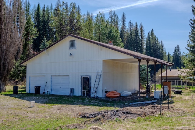 view of property exterior with an outdoor structure and a garage