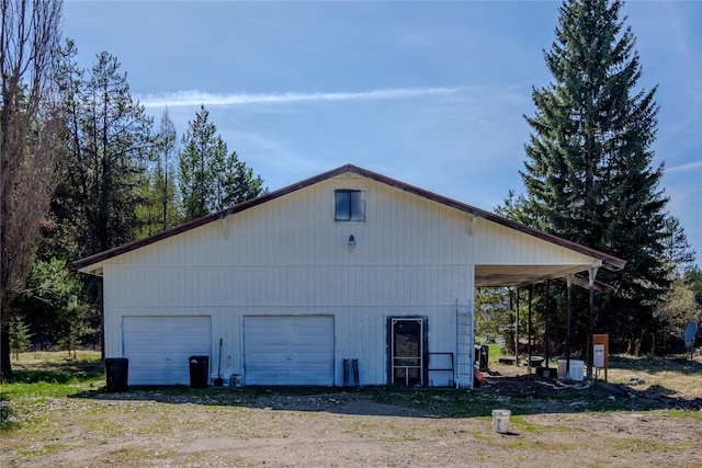 view of home's exterior with an outdoor structure and a garage