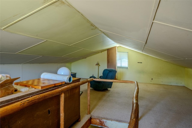 additional living space featuring lofted ceiling and carpet flooring
