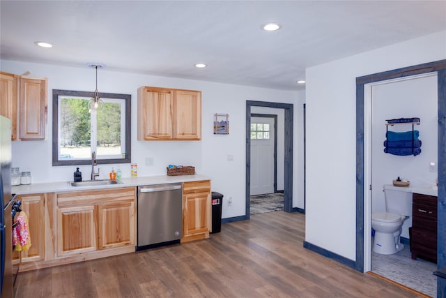 kitchen with a sink, recessed lighting, light countertops, dark wood-style floors, and stainless steel dishwasher