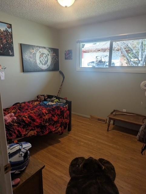 412 Raymond St, Helena, MT 59601 - bedroom featuring a textured ceiling and wood finished floors