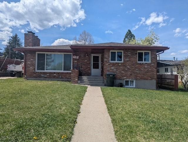 412 Raymond St, Helena, MT 59601 - view of front of house featuring brick siding and a chimney