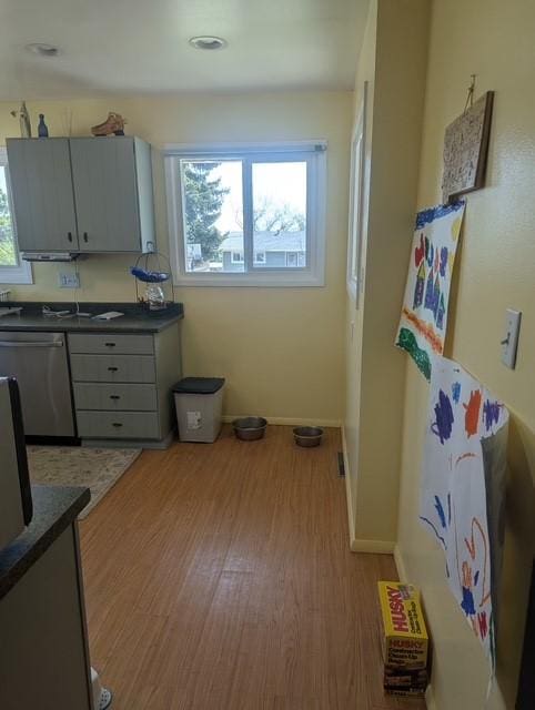 412 Raymond St, Helena, MT 59601 - kitchen featuring stainless steel dishwasher, wood finished floors, dark countertops, and baseboards