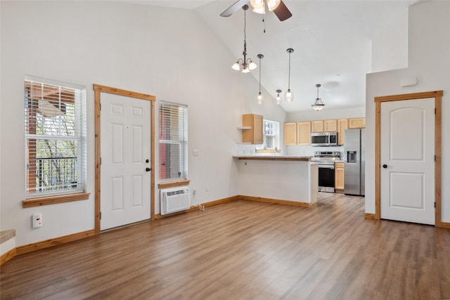 3010 Tina Ave Unit 306, Missoula, MT 59808 - unfurnished living room with light wood-type flooring, high vaulted ceiling, a ceiling fan, and a wall unit AC