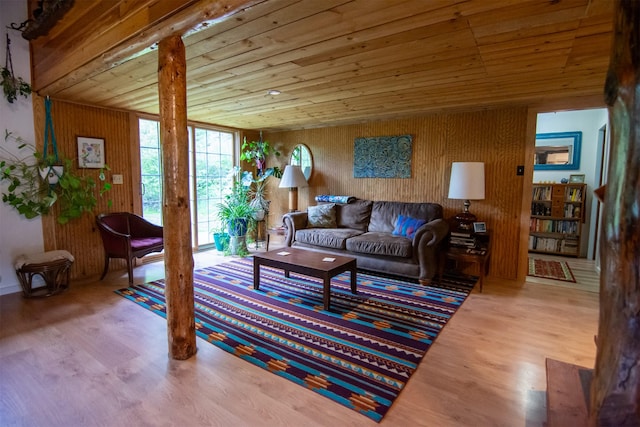 living room with wood ceiling, wood walls, and wood finished floors