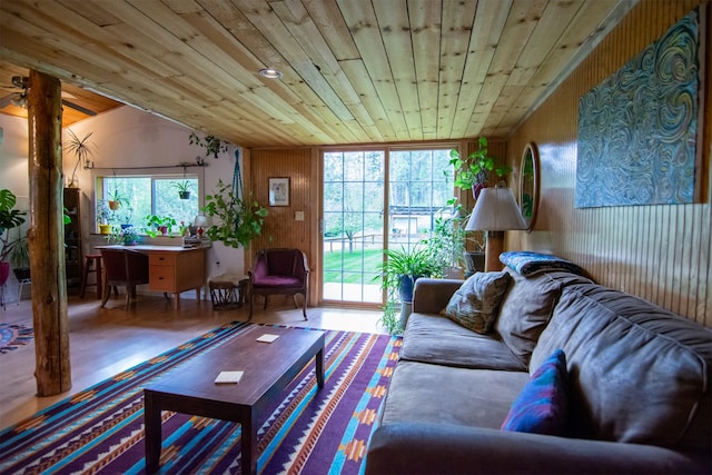living area featuring wood ceiling and wooden walls