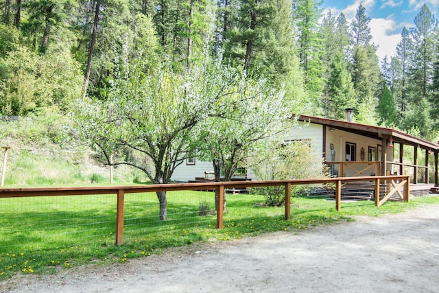 exterior space featuring a wooded view