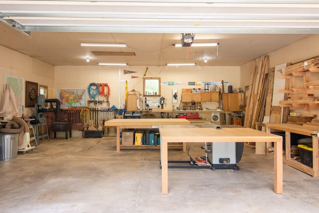 garage featuring a garage door opener and a workshop area