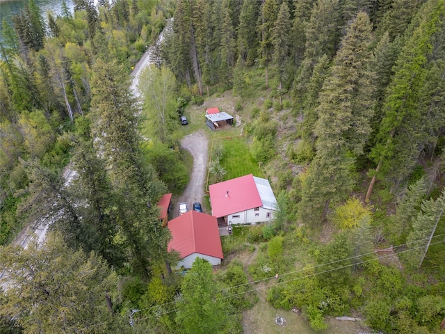 aerial view of property and surrounding area featuring a forest