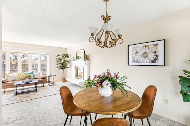 dining space with a textured ceiling, carpet flooring, and a notable chandelier