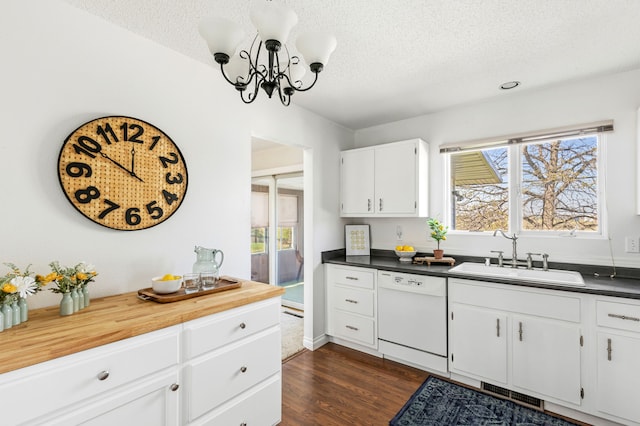 kitchen featuring a sink, a textured ceiling, visible vents, an inviting chandelier, and white dishwasher