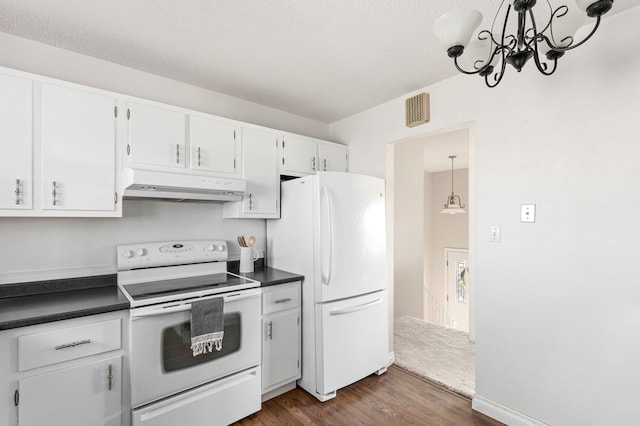 kitchen featuring dark countertops, dark wood finished floors, white cabinetry, white appliances, and under cabinet range hood