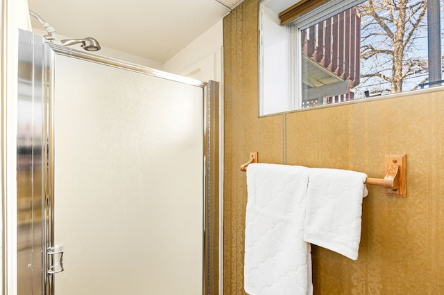 full bath featuring a shower with door