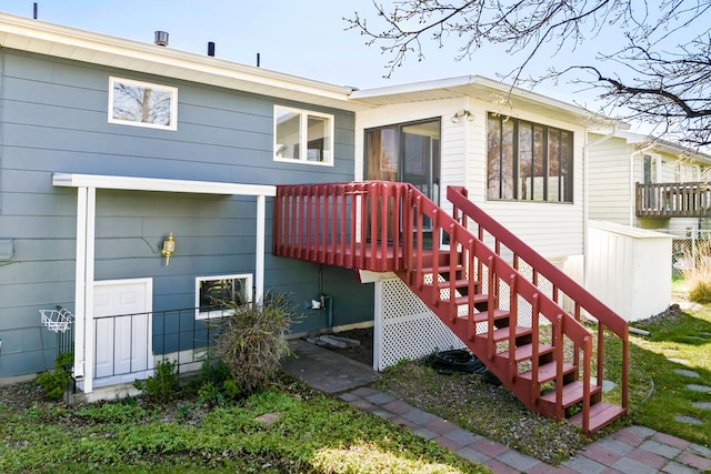 rear view of property with a wooden deck