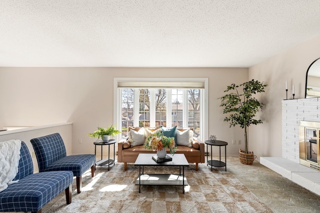 living area featuring carpet flooring, a brick fireplace, and a textured ceiling