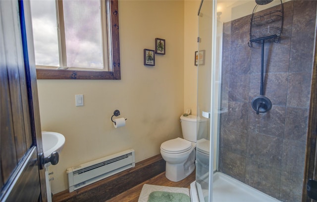 45 Bay Rd, Whitehall, MT 59759 - bathroom featuring toilet, wood finished floors, a shower stall, baseboard heating, and baseboards