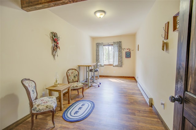 45 Bay Rd, Whitehall, MT 59759 - sitting room with wood finished floors, baseboards, and a baseboard heating unit