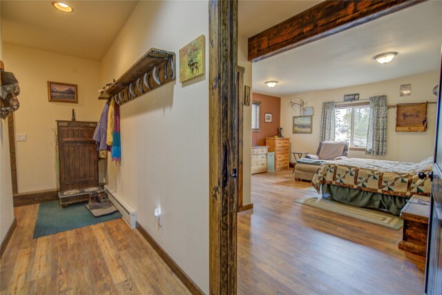45 Bay Rd, Whitehall, MT 59759 - hall with baseboard heating, wood finished floors, baseboards, and recessed lighting