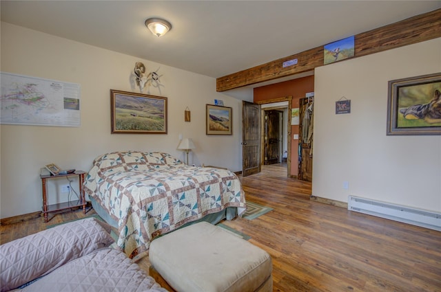 45 Bay Rd, Whitehall, MT 59759 - bedroom with a baseboard radiator, beamed ceiling, baseboards, and wood finished floors