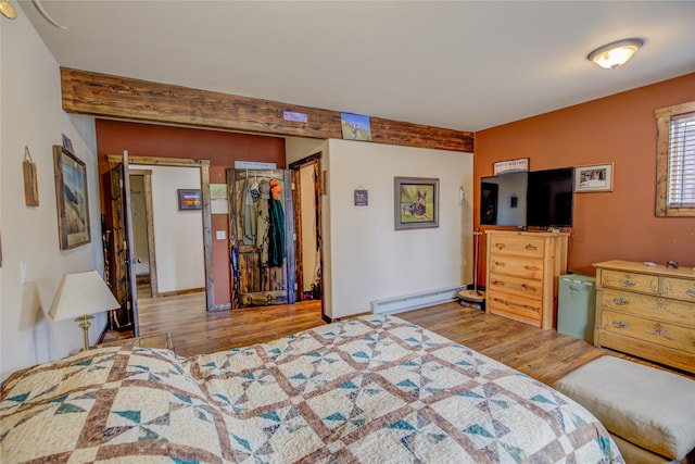 45 Bay Rd, Whitehall, MT 59759 - bedroom featuring a walk in closet, baseboards, baseboard heating, and wood finished floors