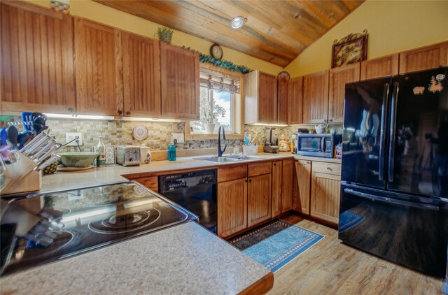 45 Bay Rd, Whitehall, MT 59759 - kitchen featuring a sink, vaulted ceiling, black appliances, light countertops, and light wood-type flooring
