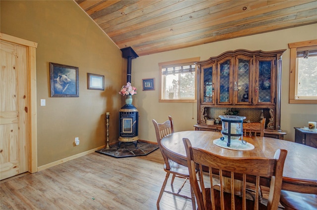 45 Bay Rd, Whitehall, MT 59759 - dining space featuring a wood stove, light wood-style floors, vaulted ceiling, and a healthy amount of sunlight