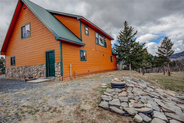 45 Bay Rd, Whitehall, MT 59759 - rear view of house with metal roof and stone siding