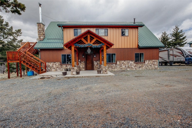 45 Bay Rd, Whitehall, MT 59759 - view of front of home featuring stone siding, stairway, a chimney, and metal roof