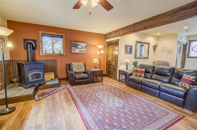 45 Bay Rd, Whitehall, MT 59759 - living area featuring wood finished floors, a wood stove, recessed lighting, beamed ceiling, and a ceiling fan
